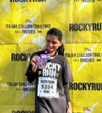 Krishna at the Rocky Run finish line with a medal